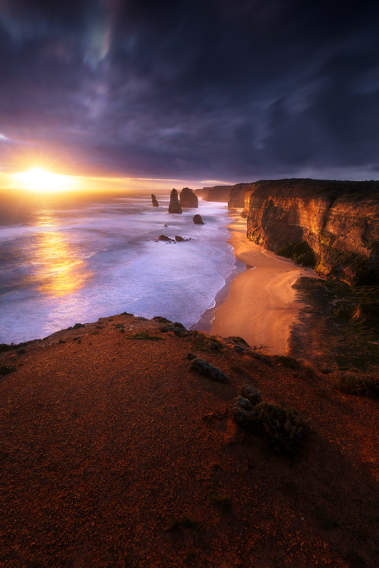 A fiery sunset at the iconic Australian coastline of the 12 Apostles